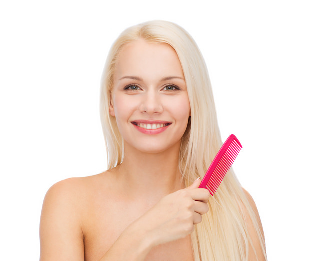 smiling woman with hair brush