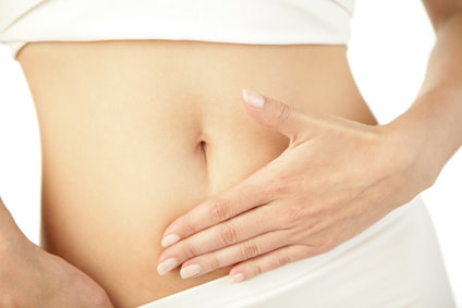 Closeup of young woman with hand on her stomach