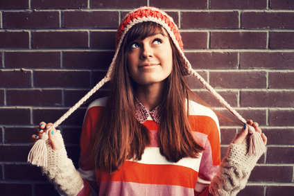 Portrait of young pretty funny smiling girl in cold weather