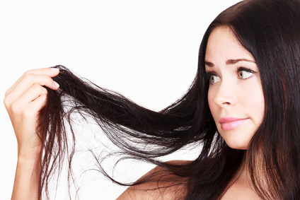 brunette woman is not happy with her fragile hair