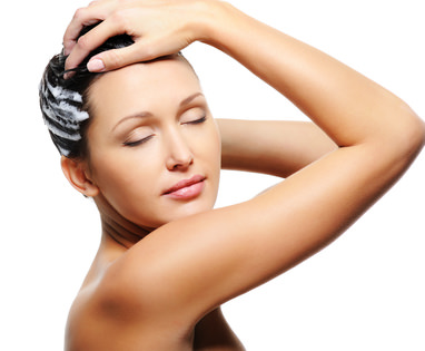 woman washing her head with shampoo