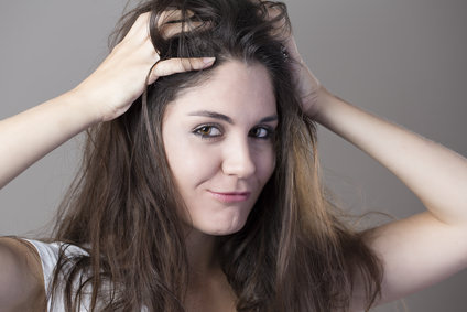 Portrait of a young brunette woman making faces with different e