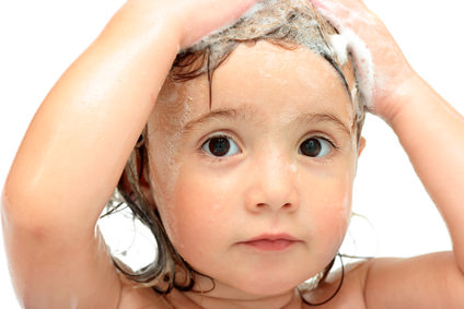 Lovely washing baby-girl with soap isolated over white