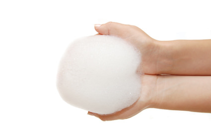 Foam of soap and female hands