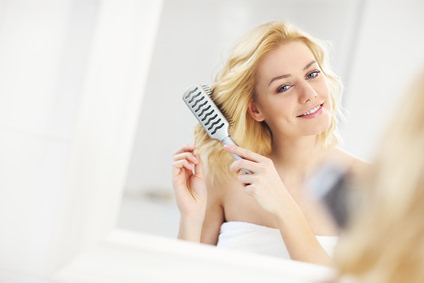 Young woman brushing hair