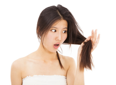 shocked woman watching the damage hair and splitting ends