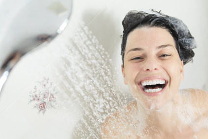 Shower woman. Happy smiling woman washing shoulder showering in