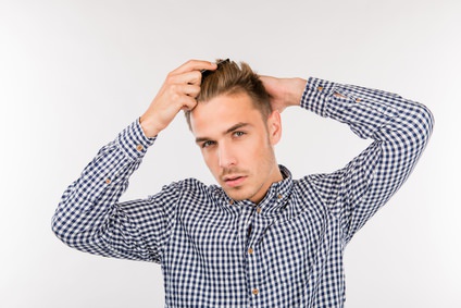 handsome young man brushing his hair