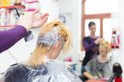 Hairdresser salon. Woman during hair dye.