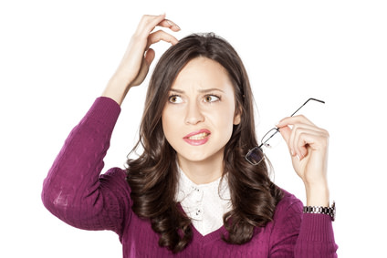 Thoughtful young woman scratching her head