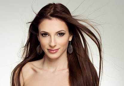 Close-up of pretty female salon model with flying hair